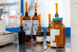 Bottles of oils in lab. with syringes in them